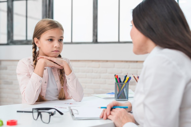 young-child-psychologist-talking-with-sad-little-girl-office_23-2148026278.jpg